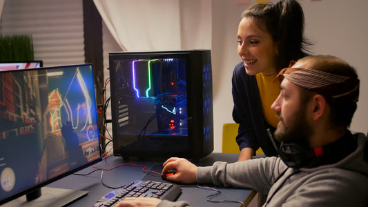 Two gamers playing a first-person shooter on a PC with RGB lighting and gaming headphones